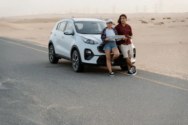 Couple on a scenic road trip looking out at a wide landscape