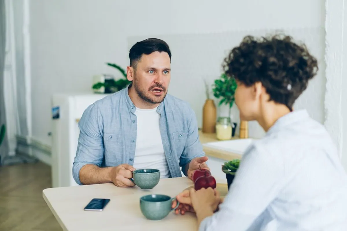 Two people in a quiet, warm conversation at home