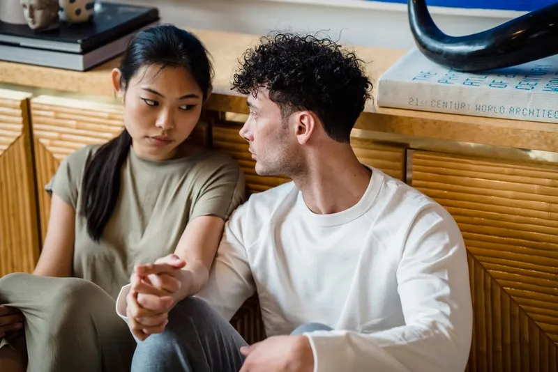 Couple in a calm, thoughtful conversation at home about their desire styles