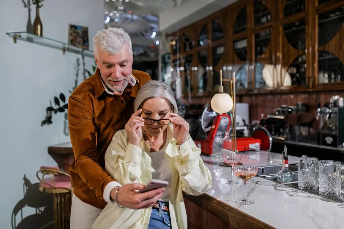 Couple making a decision together while looking at a phone