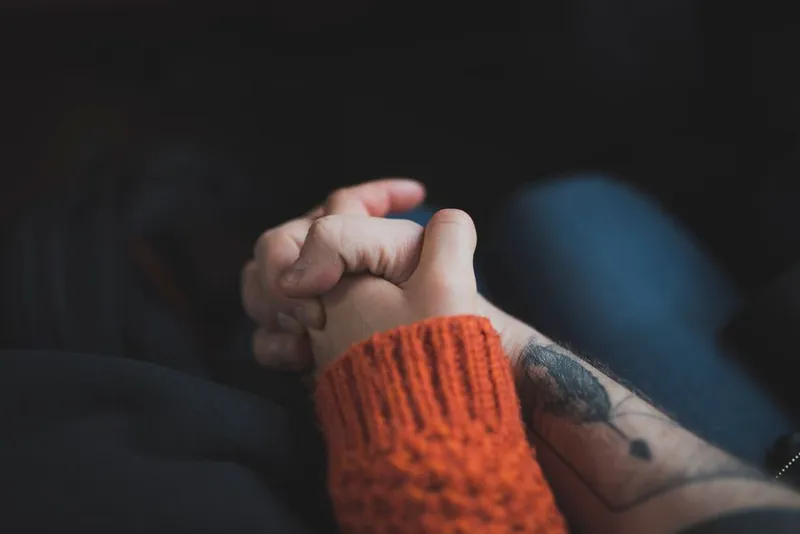 Couple holding hands in warm, soft light