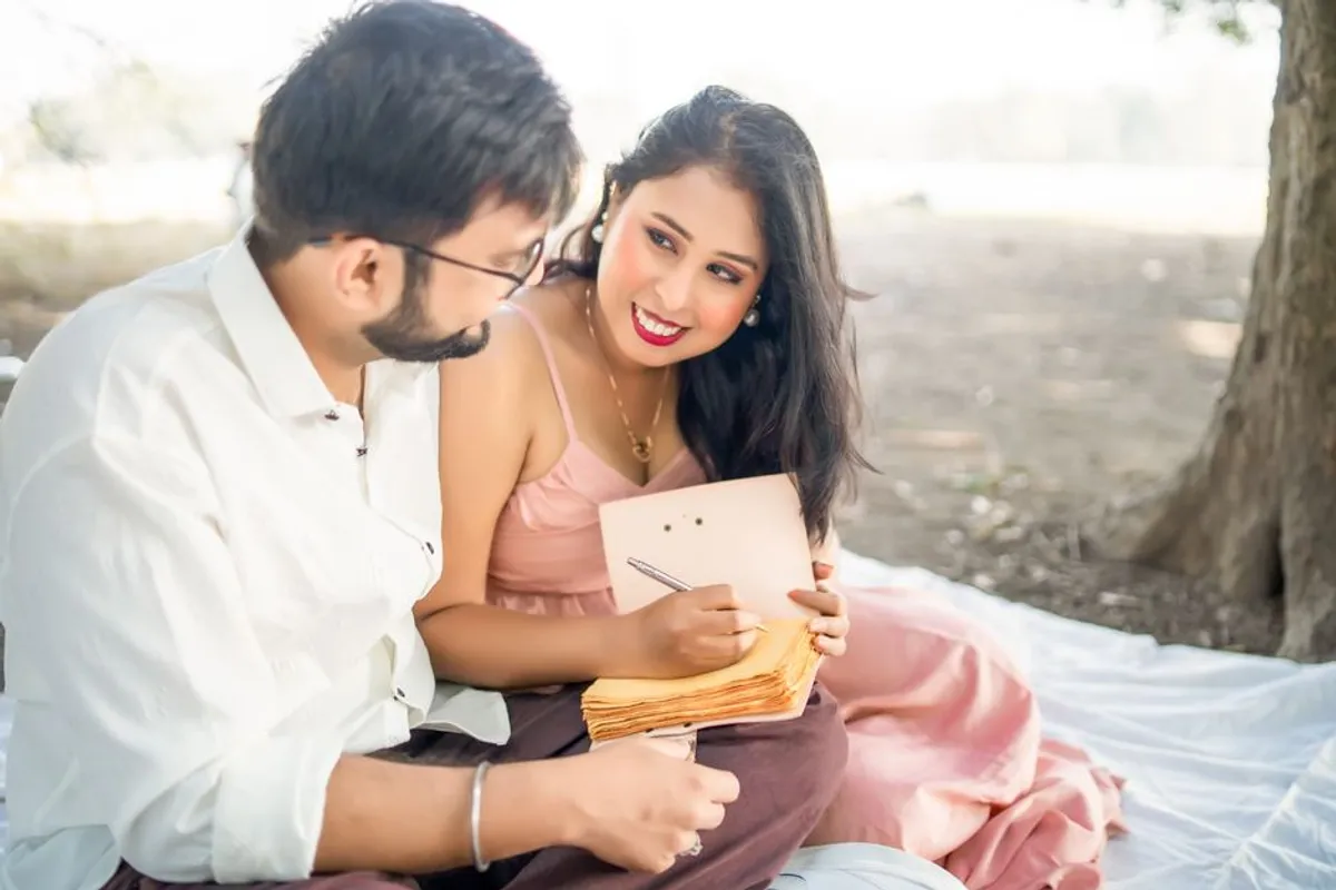 Couple writing notes together thoughtfully