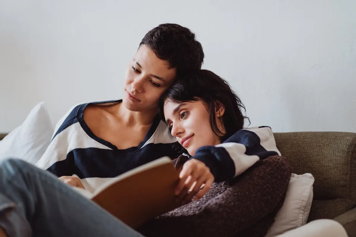 Couple reading together at home, relaxed and comfortable