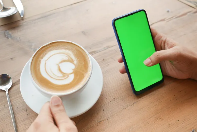 Couple sharing a quiet morning moment together with coffee and phones