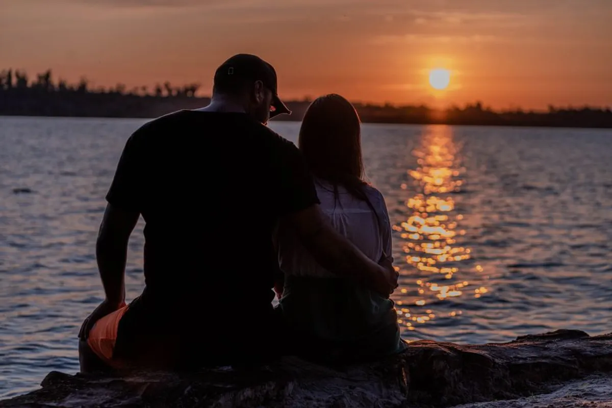 Couple sitting together in the evening with a notebook
