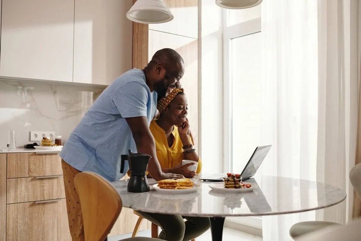 Couple sitting quietly together at a kitchen table