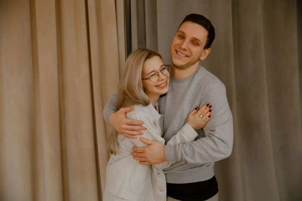 Couple embracing warmly indoors