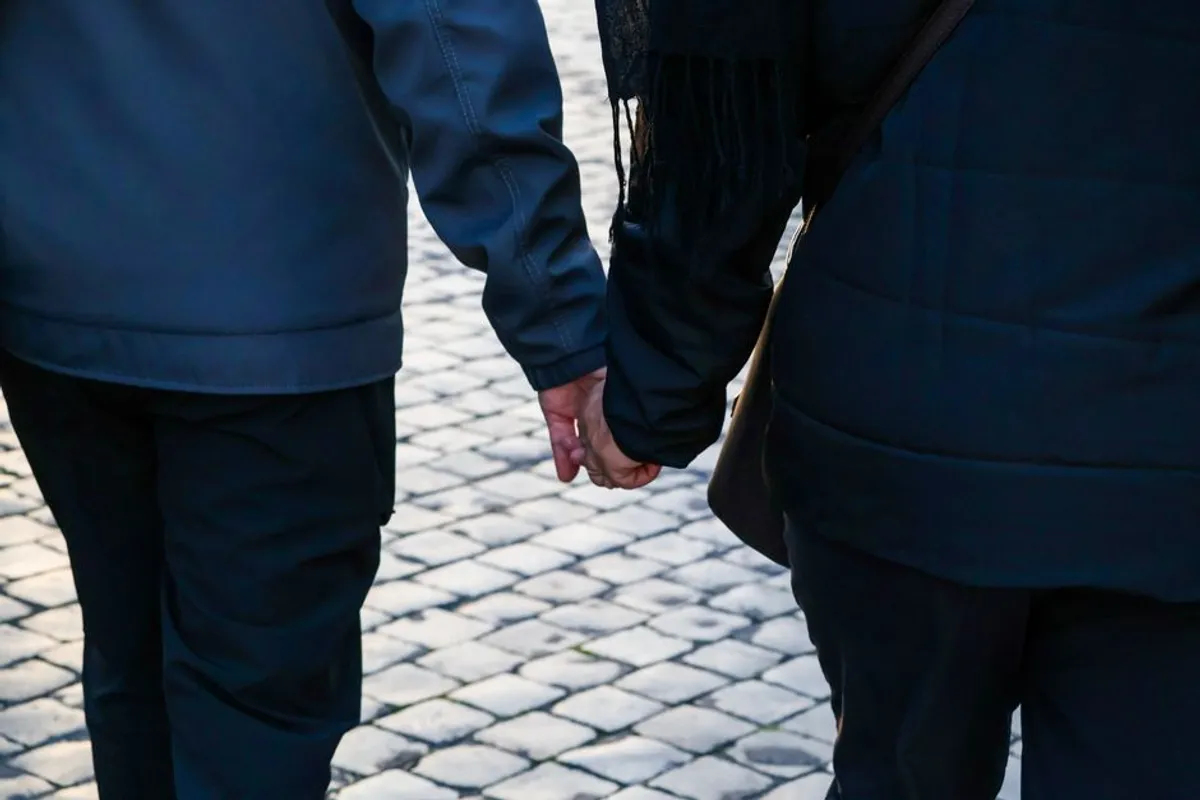 Couple holding hands on an evening walk