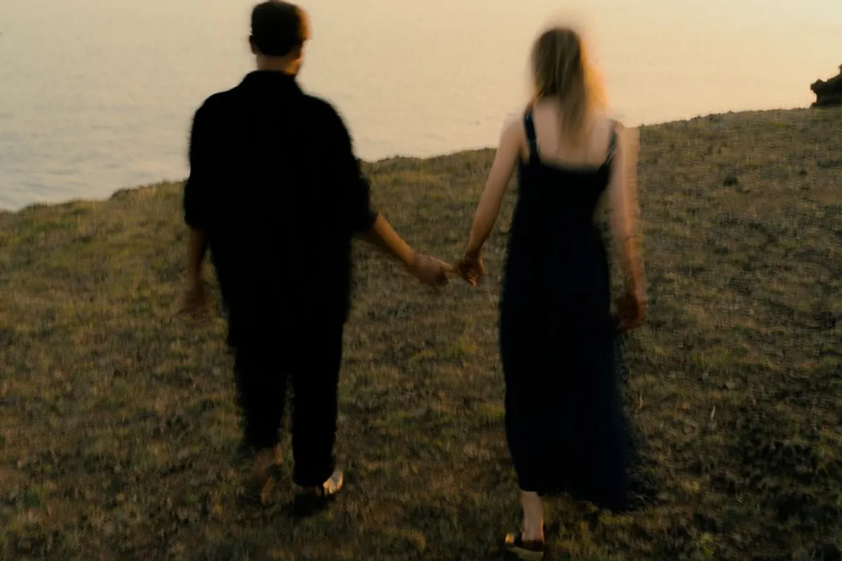 Couple holding hands on an evening walk