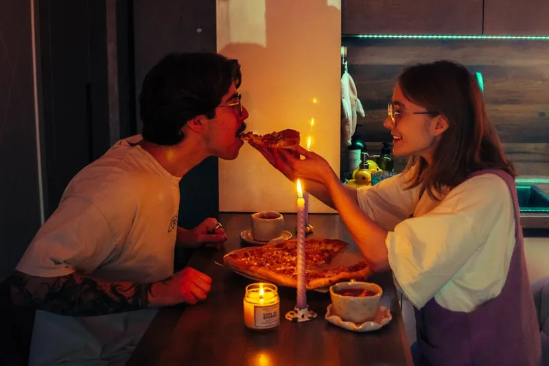 Couple having a candlelit dinner together at home