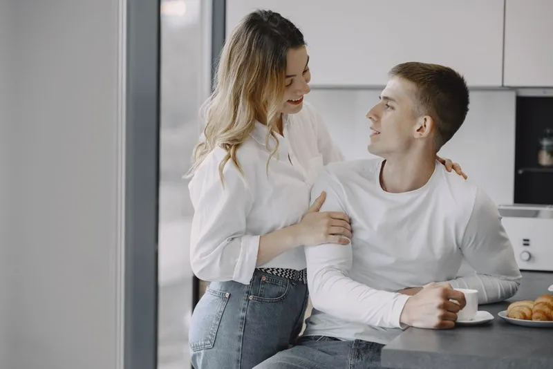 Couple having coffee together in a warm kitchen