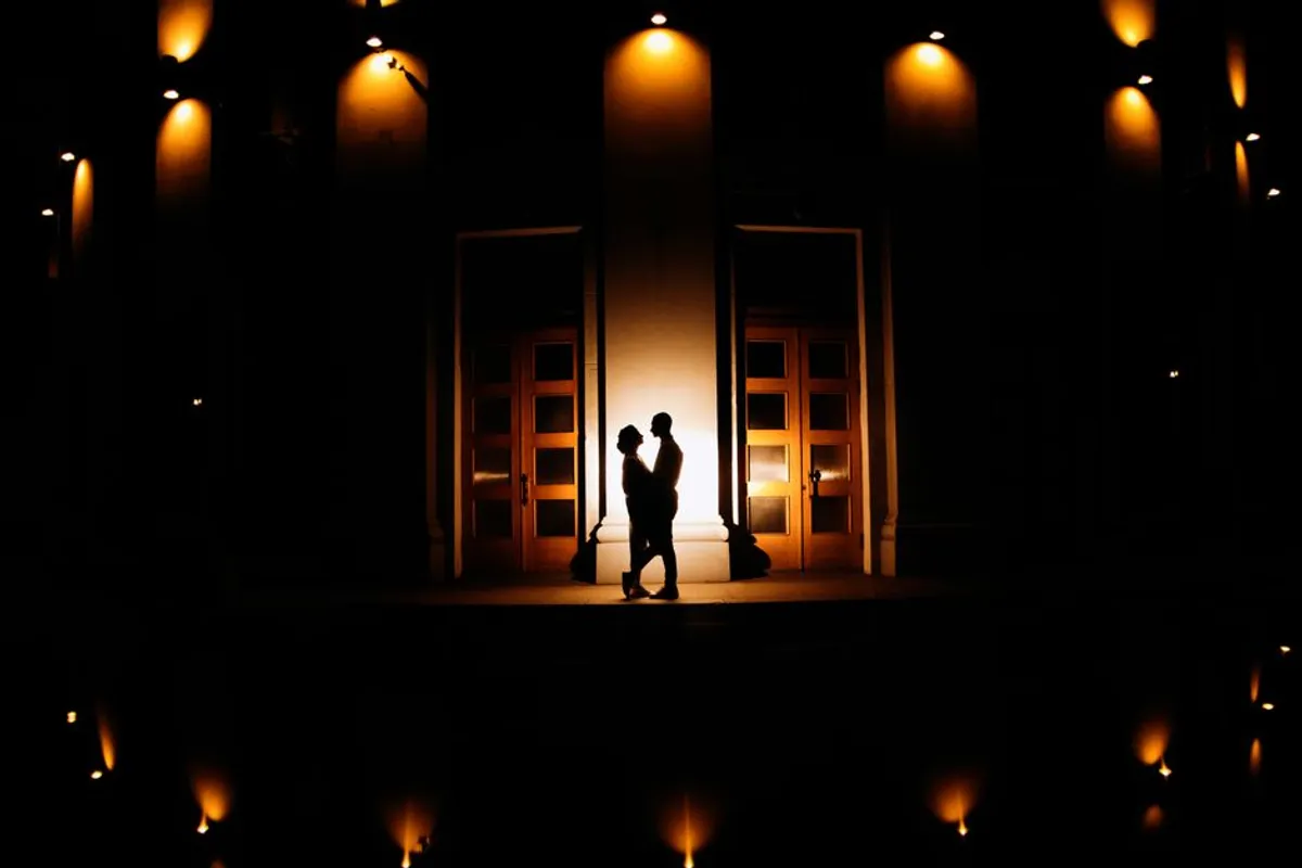 Couple at a doorway at home in warm evening light