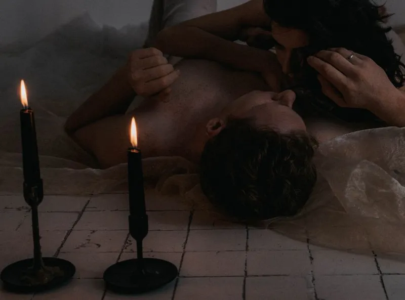 Couple close together in warm candlelight at home in the evening