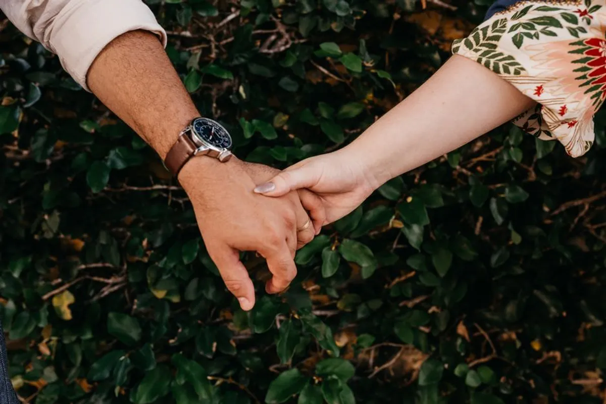 Two hands close together in soft light