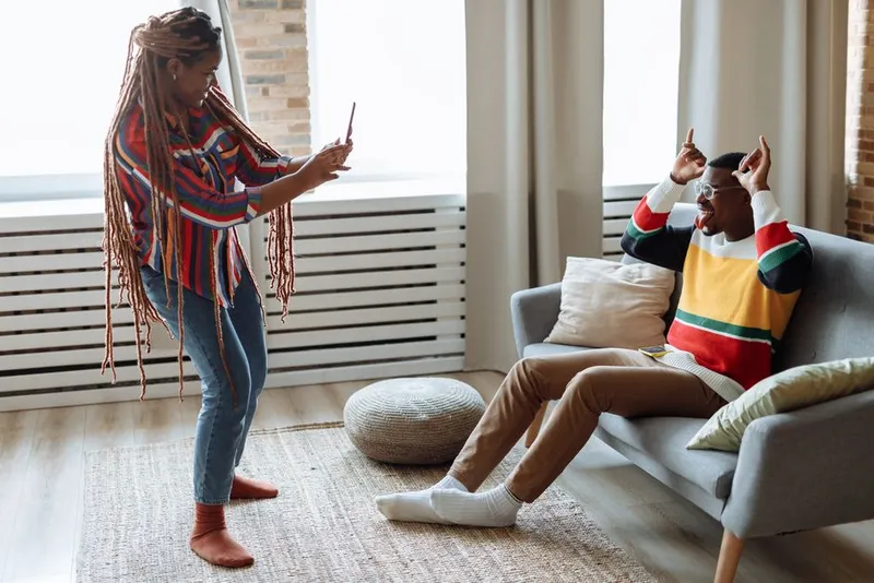 Couple laughing and playful together at home in the evening