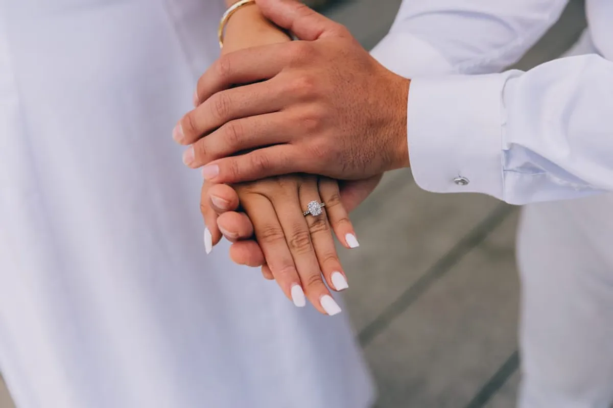 Two hands held together in support