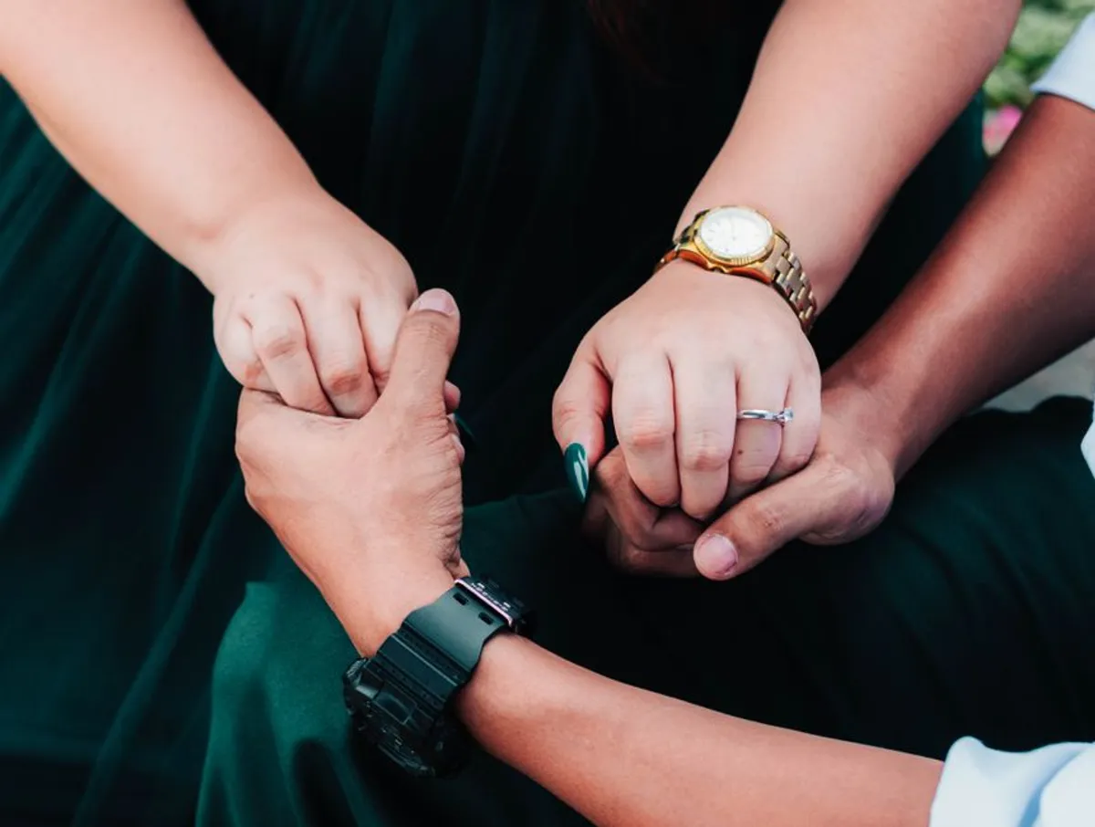 Two hands held together in support