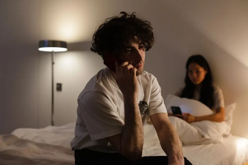 Two people using their phones privately at home